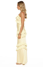 Side view of a yellow satin maxi dress with spaghetti straps and tiered ruffles on the bodice and skirt