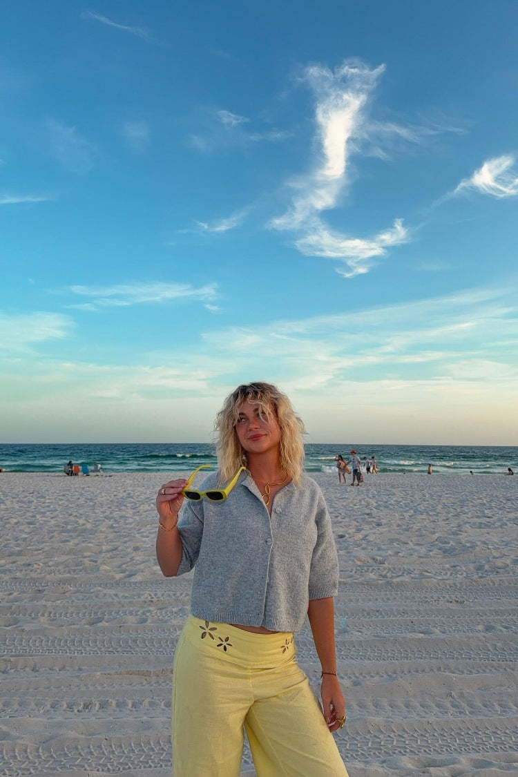 Front view of a light grey short sleeve cropped cardigan with a collared neckline and full button-front