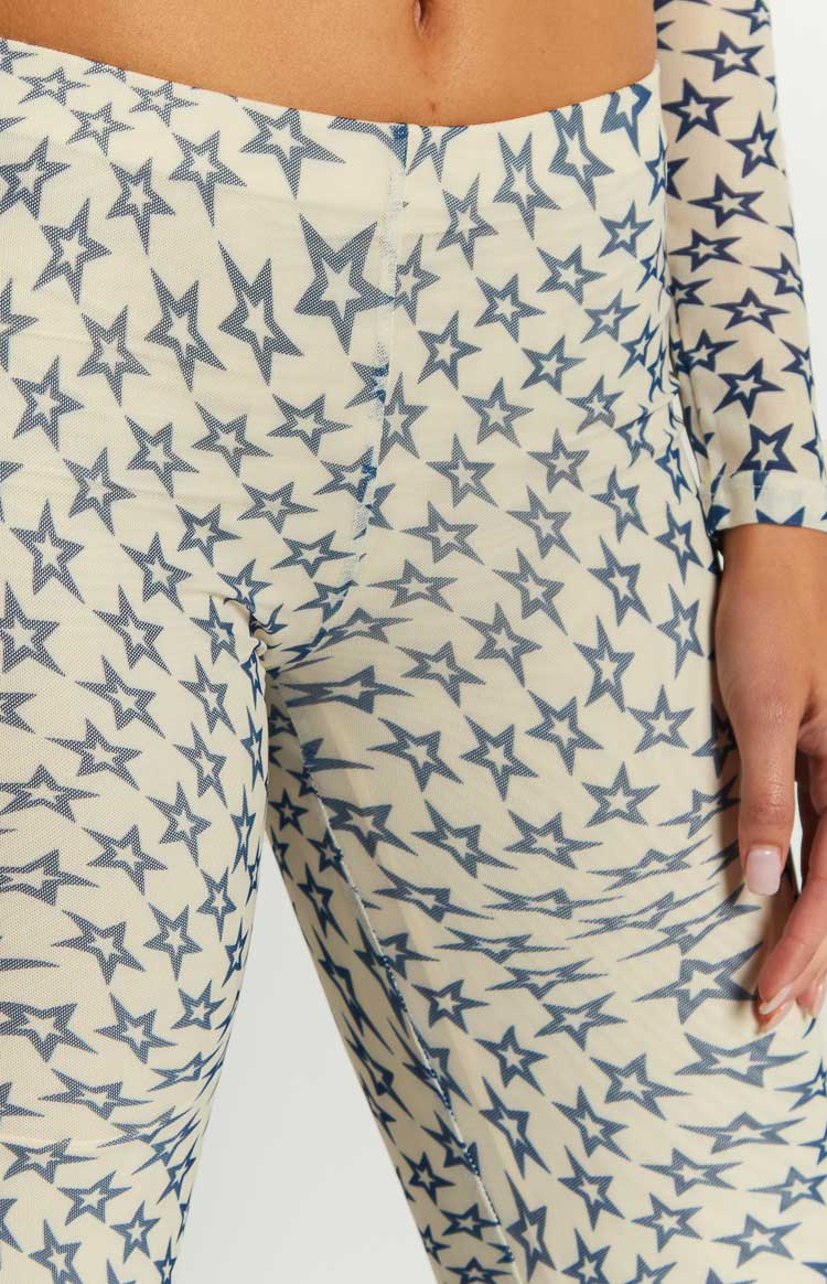 Close-up of the sheer cream mesh pants with a dense blue star print and visible seam