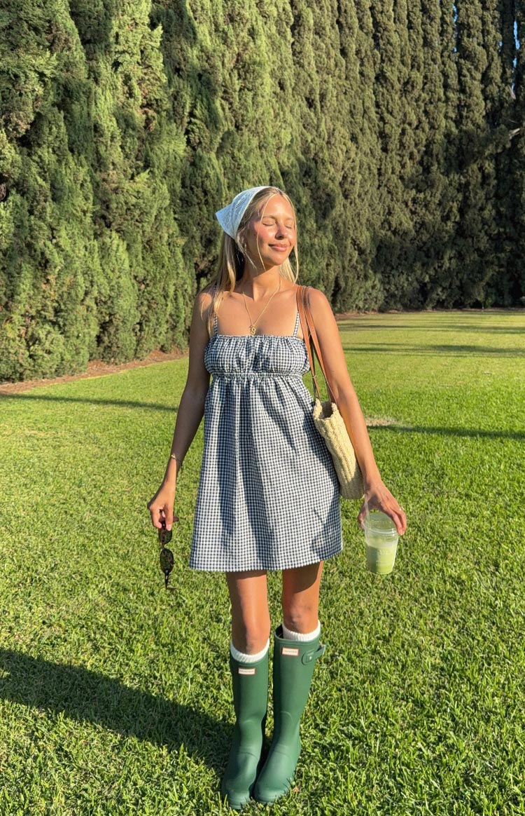 Black gingham mini dress with thin spaghetti straps, a gathered bust, and a flowy A-line skirt