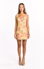 Front view of a yellow floral mini dress with a square neckline and a side tie detail