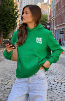 Rear view of a green hoodie with a white 'Beginning' graphic print and heart details on the back