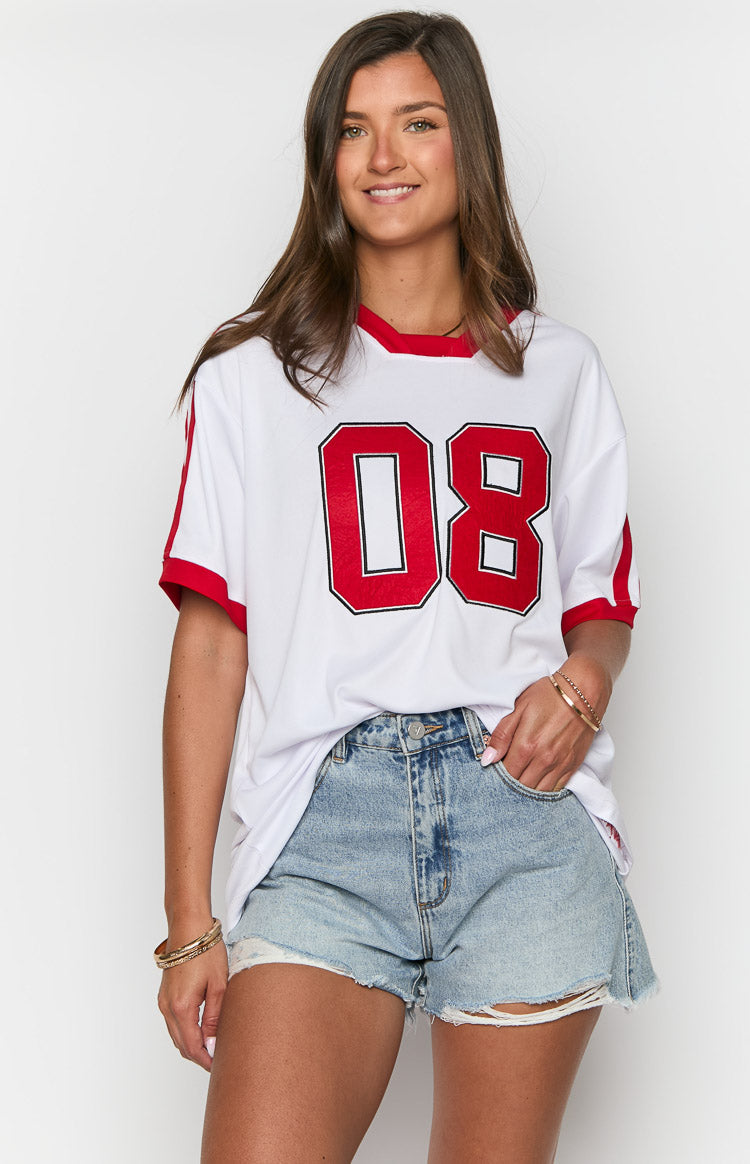White oversized jersey mini dress with red ribbed crew neck, red stripe detail on short sleeves, and large red '08' numbers