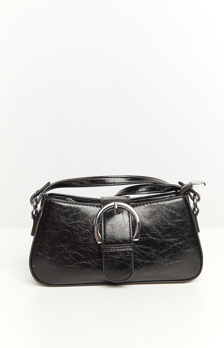 Black PU bag with a silver buckle on the front flap, crinkled texture, top zipper, and a top handle