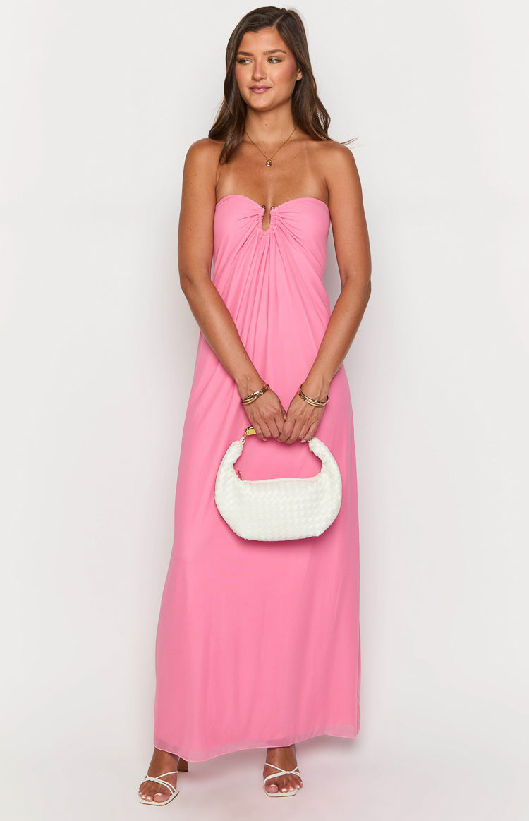 Front view of a pink strapless maxi dress with a gold ring detail at the center bust creating a gathered effect