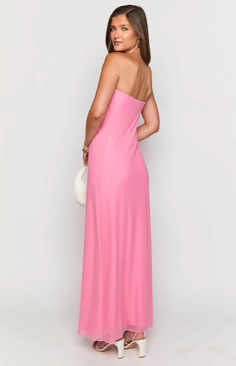 Side view of the pink strapless maxi dress, highlighting the straight-cut back and the flowing, slightly sheer maxi skirt
