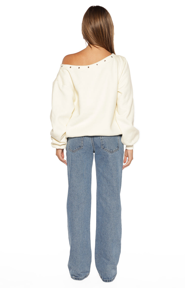 Rear view of the cream asymmetric neckline sweater showing the eyelet detail across the back