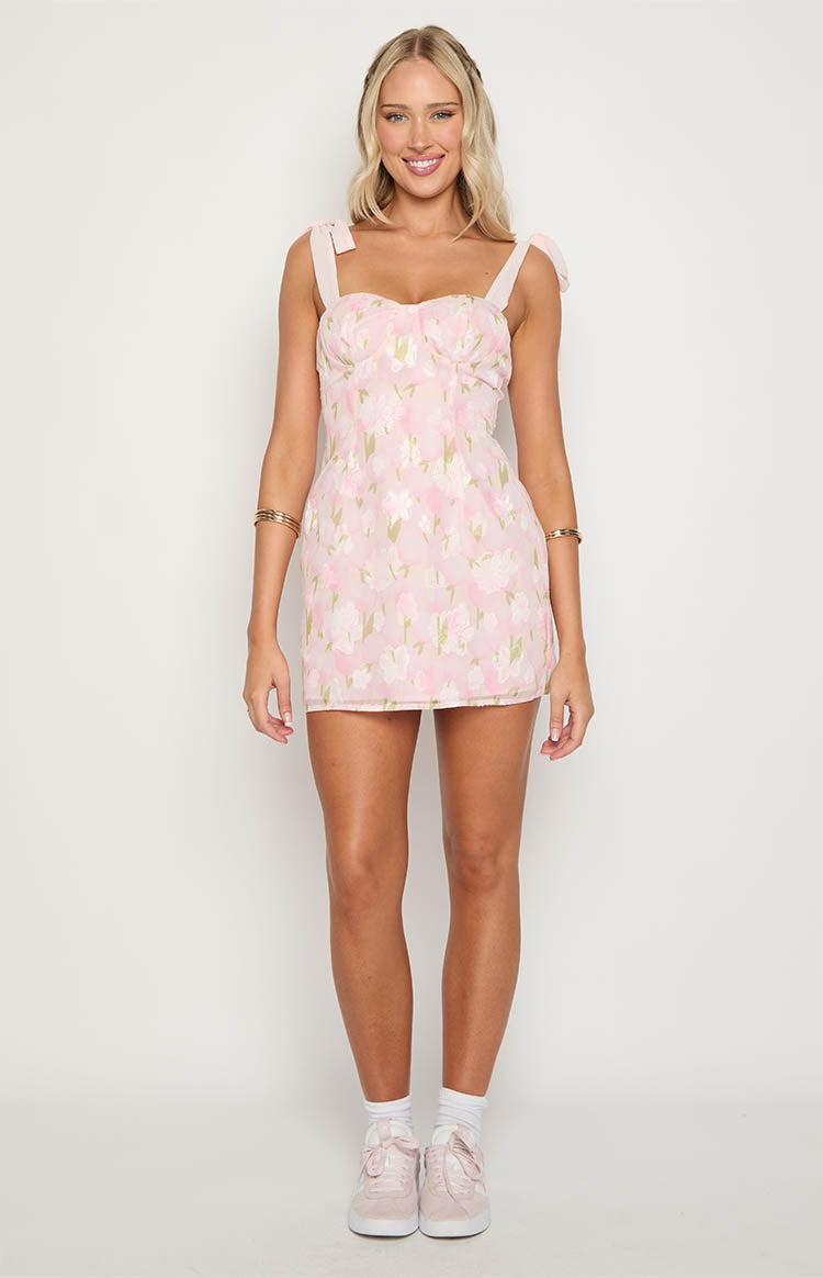 Pink floral mini dress with a sweetheart neckline, tie-shoulder straps, and a subtle textured pattern