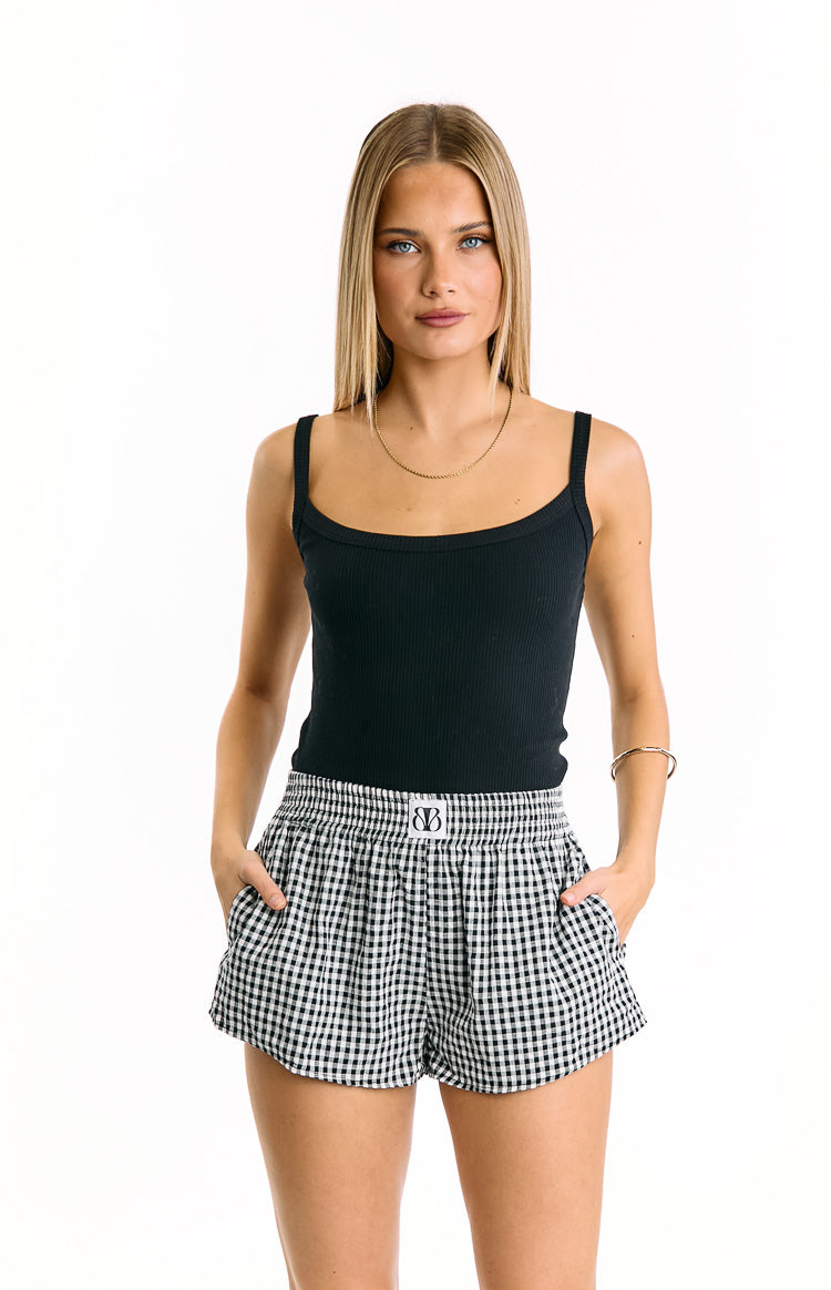 Front view of black gingham shorts with an elasticated ruched waistband and side pockets