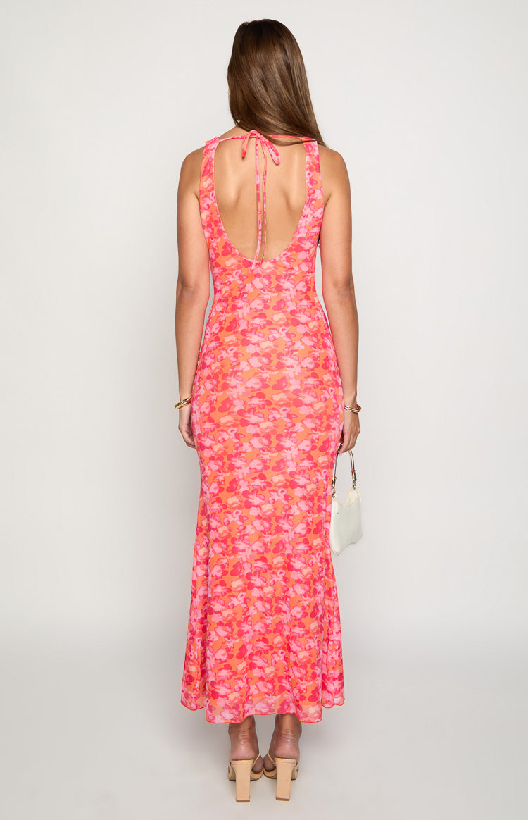 Rear view of the orange and pink floral print maxi dress with a low scoop back and tie-up halter neck