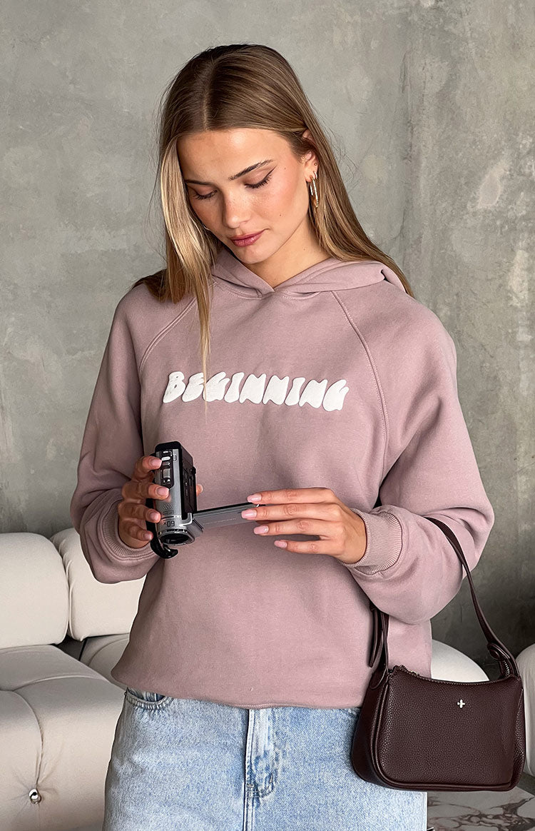 Front view of a mauve hoodie with white 'BEGINNING' bubble graphic and raglan sleeves