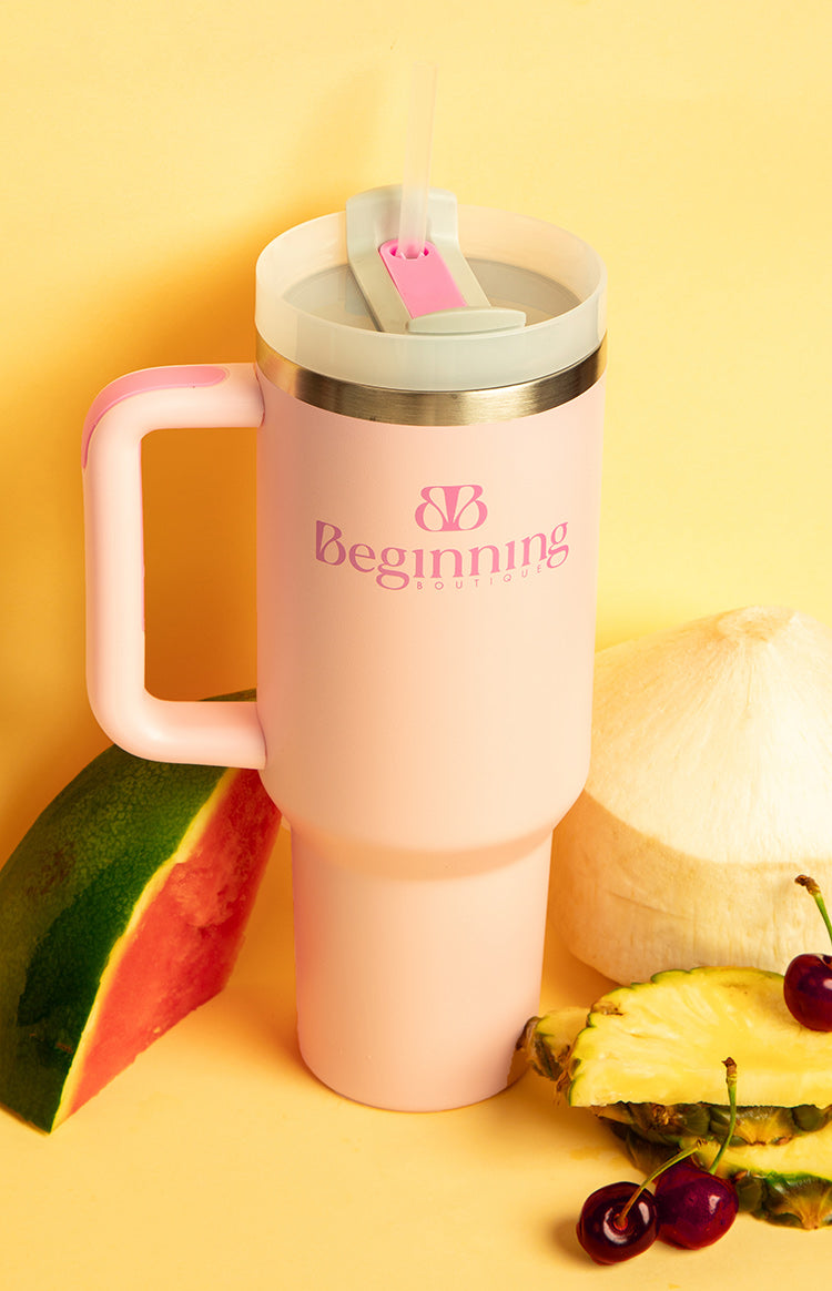 Pink tumbler with a white lid, pink flip-top straw opening, clear straw, and matching pink handle