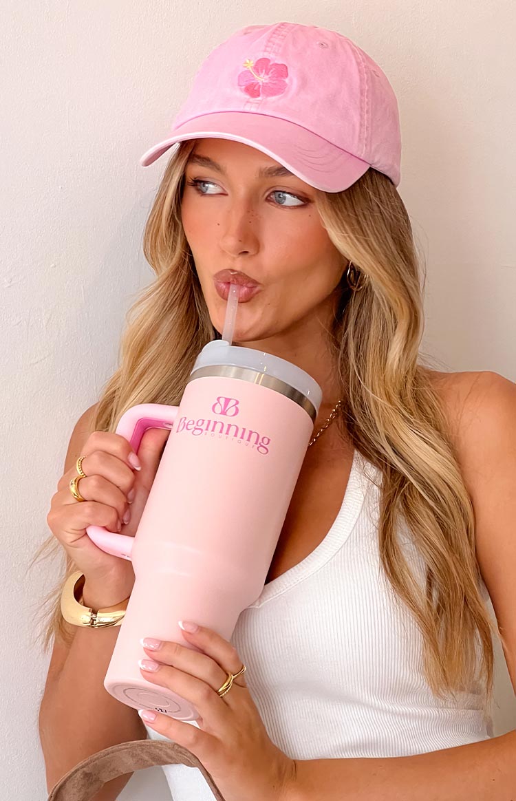 Pink bubblegum tumbler with a matching handle, silver rim, grey lid, clear straw, and pink brand logo