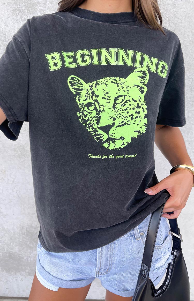 Close-up of the washed black tee with neon green 'BEGINNING' text, leopard cub graphic, and 'Thanks for the good times!' slogan