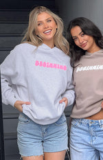 Grey marl oversized hoodie with bright pink bubble BEGINNING text, shown next to a beige hoodie