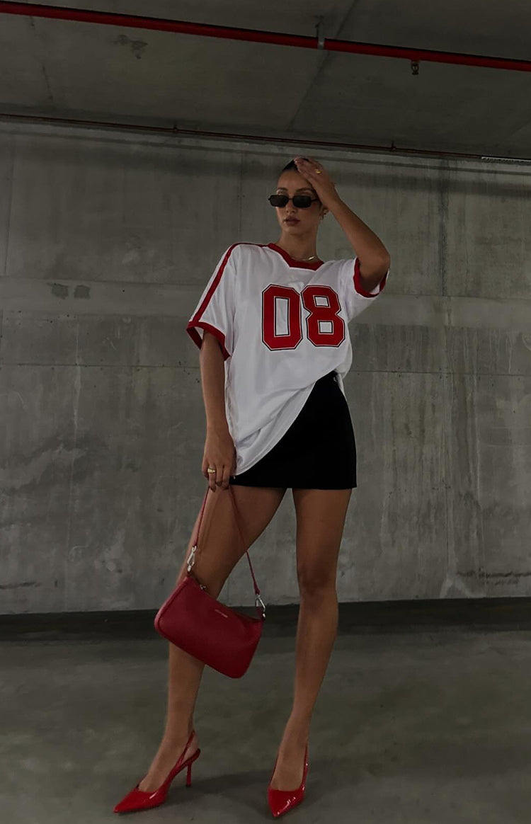 Beginning Boutique Beginning White Jersey Mini Dress oversized white jersey mini dress with red V-neck trim short sleeves and front 08 graphic