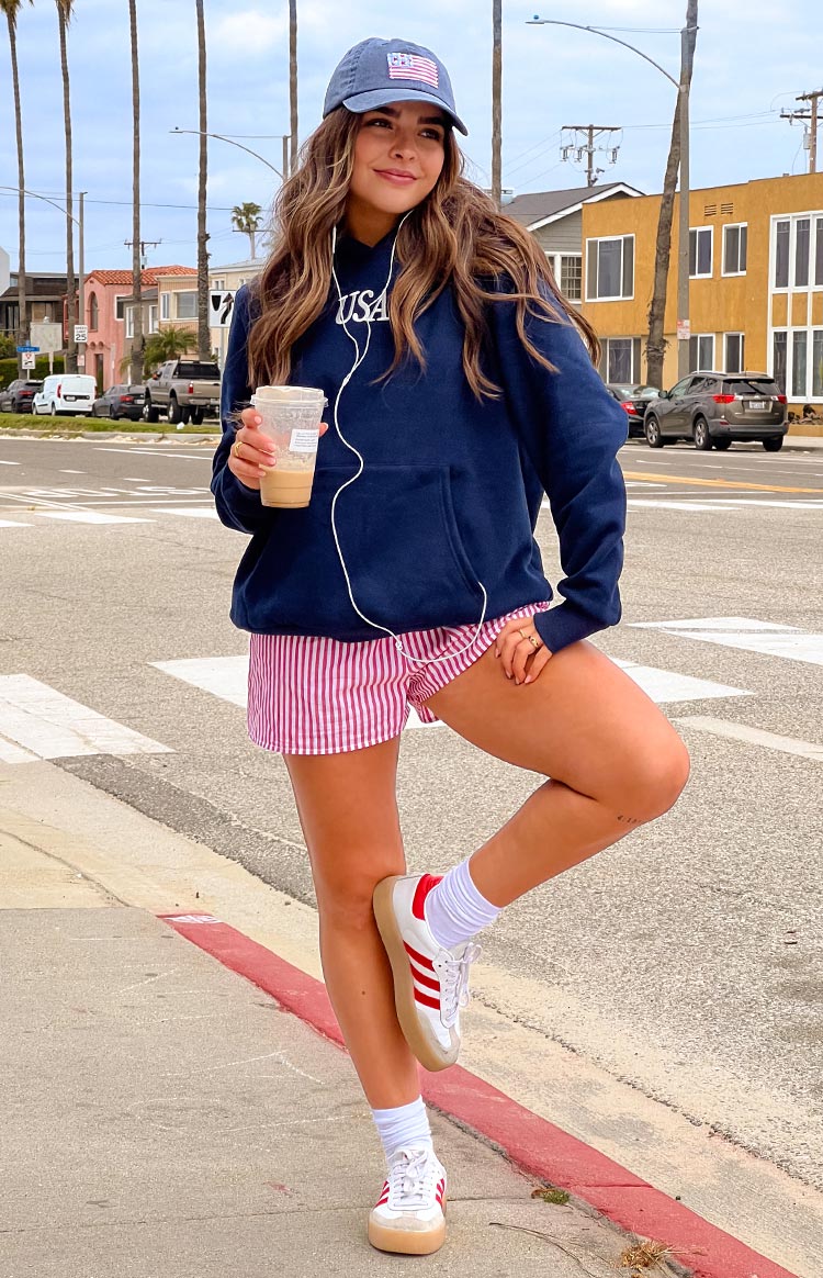 Front view of a navy oversized hoodie with white USA text on the chest and a kangaroo pocket