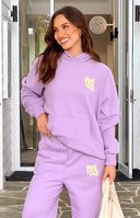 Rear view of a purple hoodie with yellow raised 