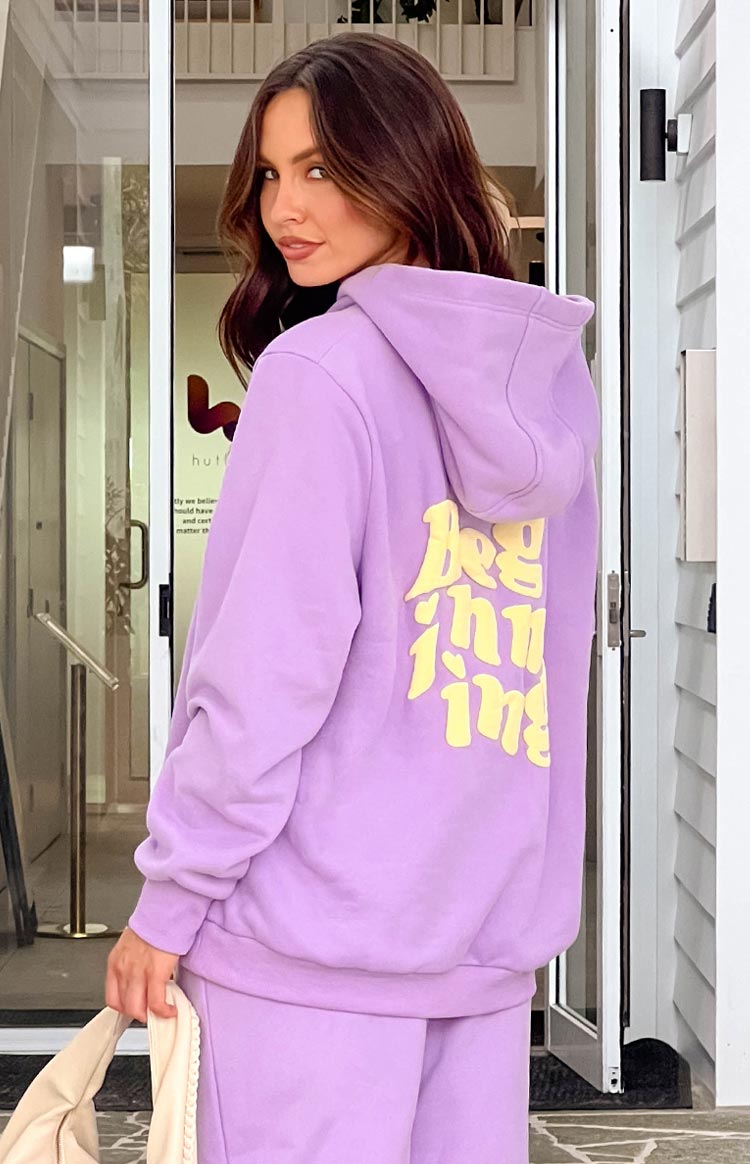 Rear view of a purple hoodie with a large yellow 'Beginning' graphic print on the back