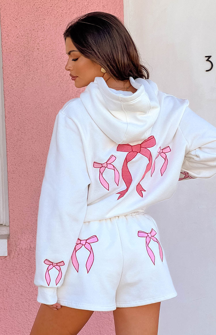 Rear view of white lounge shorts with pink bow graphics on the back and an elasticated waist