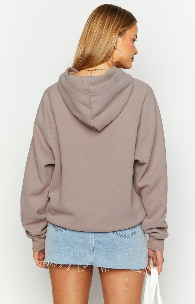 Rear view of a beige oversized hoodie with raglan sleeves and a gathered hem