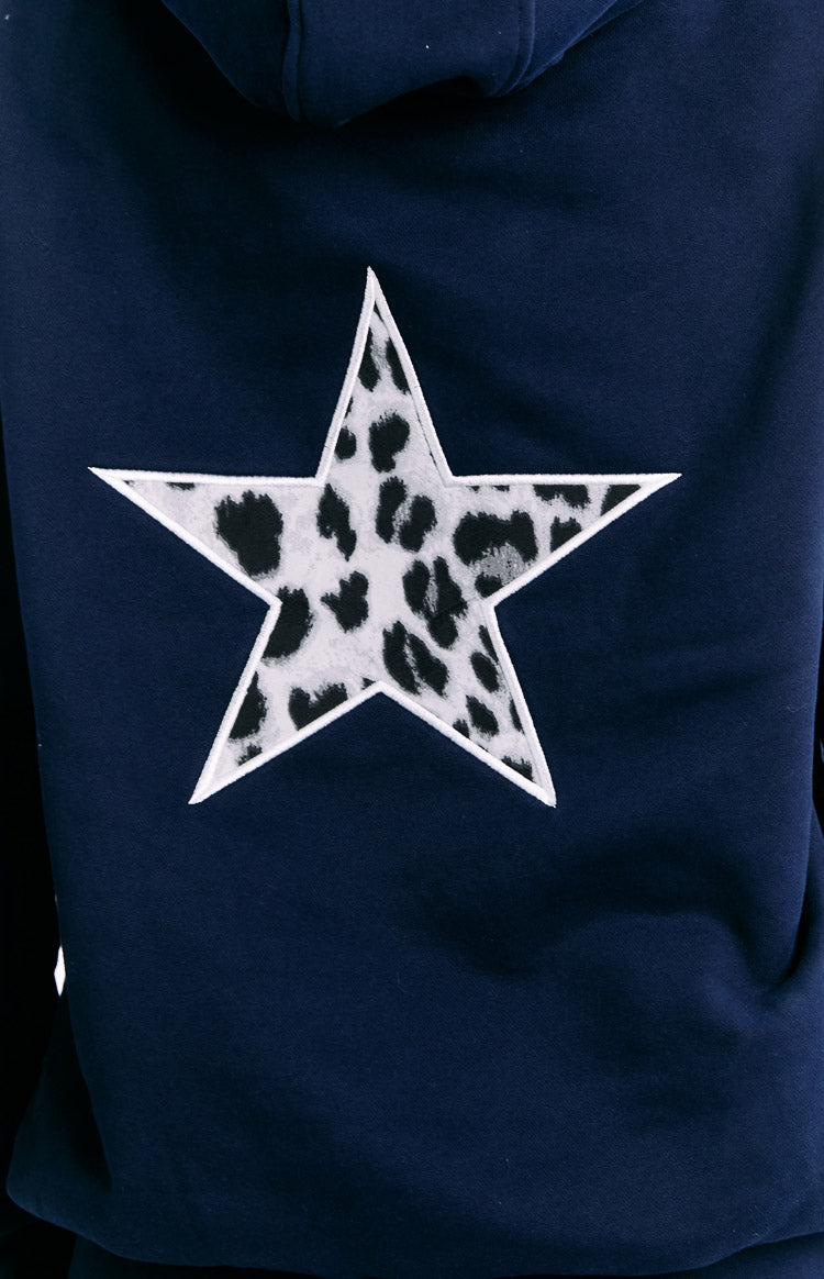 Close-up of the white star with black and white leopard print fill on the back of a navy hoodie