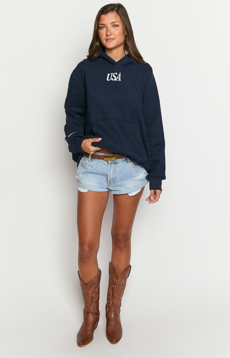Front view of an oversized navy hoodie with a white "USA" graphic, long sleeves, and a kangaroo pocket