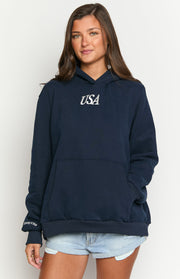 Front view of a navy oversized hoodie with white USA text, kangaroo pocket, and Emmy X BB cuff detail