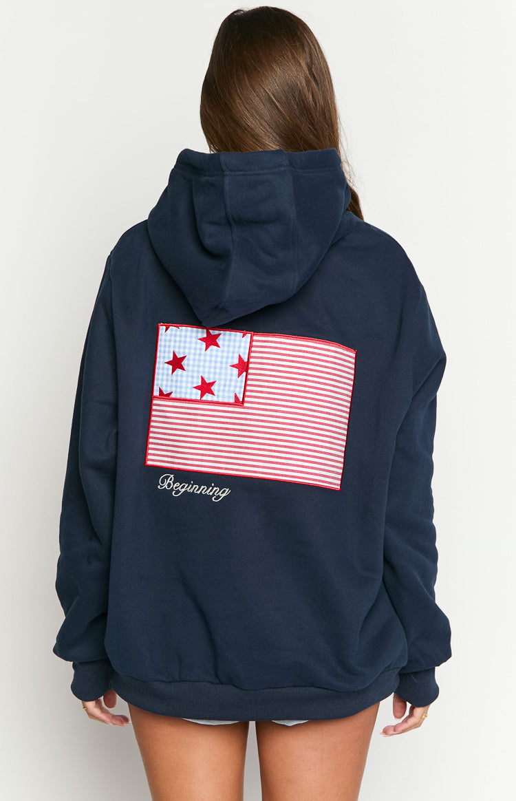 Rear view of a navy hoodie with a USA flag design, red and white stripes, blue gingham with red stars, and 'Beginning' text