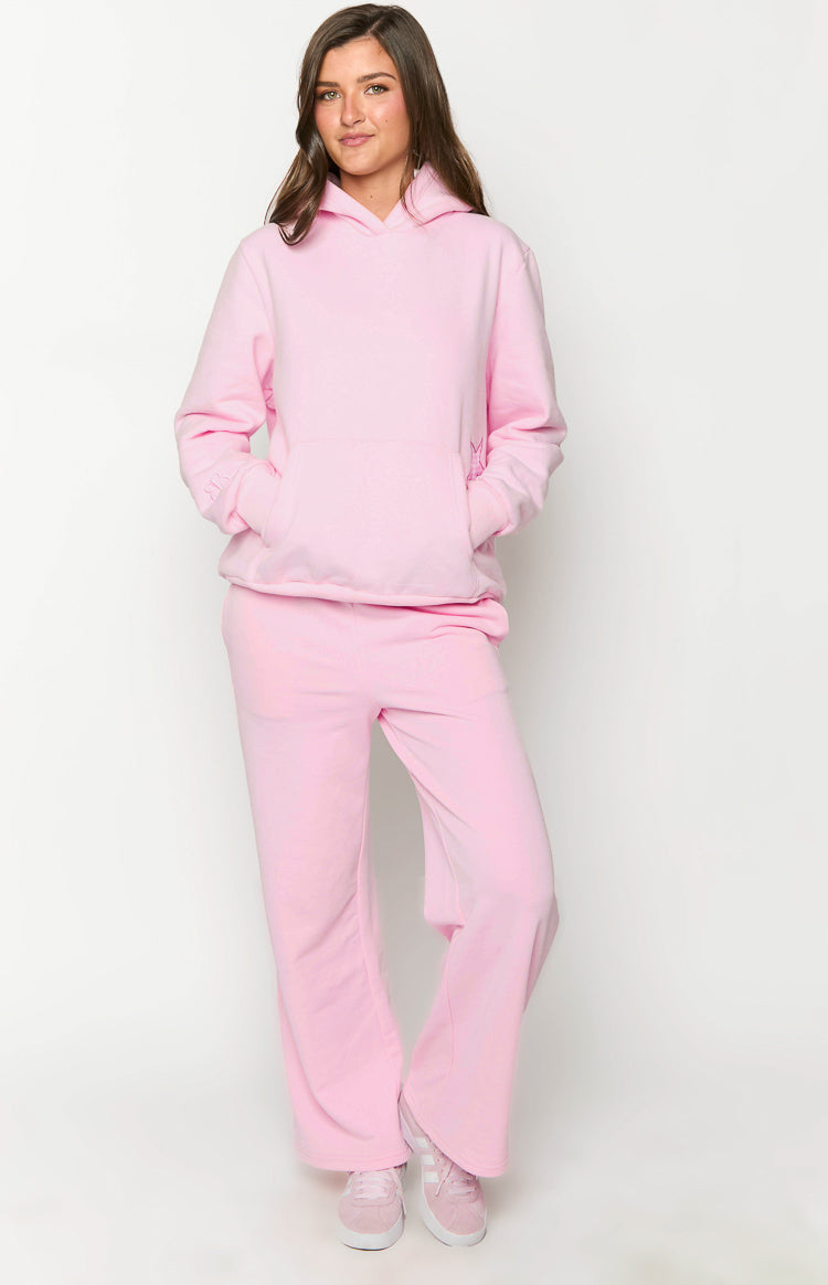 Pink hooded sweatshirt with a front kangaroo pocket and subtle star embroidery on the sleeves