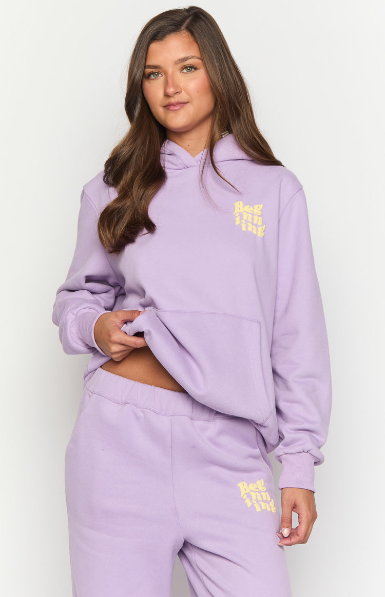 Purple oversized hoodie with yellow 'Beginning' logo on chest and matching sweatpants with elasticated waistband