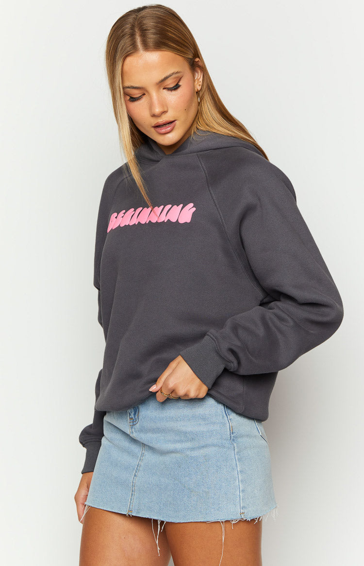 Charcoal grey hoodie with pink 'BEGINNING' text on the front, featuring raglan sleeves and ribbed cuffs