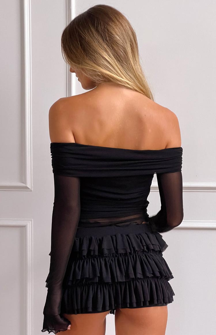 Rear view of black shorts with three tiers of gathered ruffles and a fitted waistband