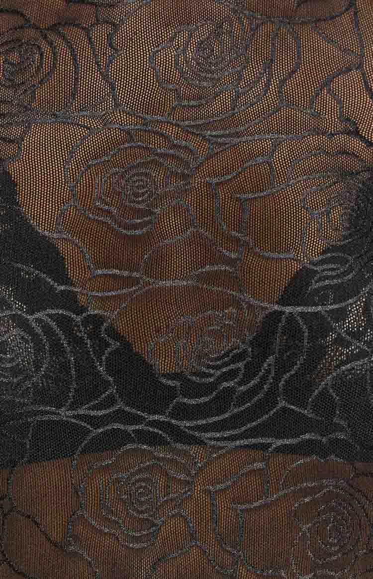 Close-up of the sheer black mesh top fabric showing a textured rose pattern