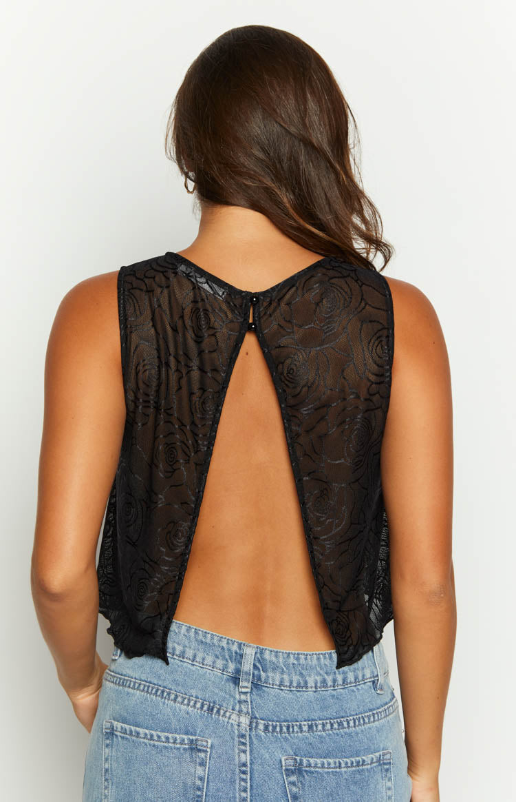 Rear view of a black mesh top with a keyhole cutout at the neck and an open back, featuring a rose pattern