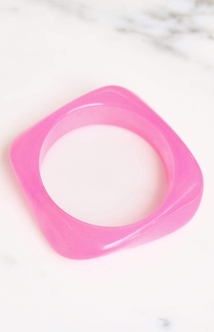 Translucent pink resin bangle with a square shape and softly rounded corners