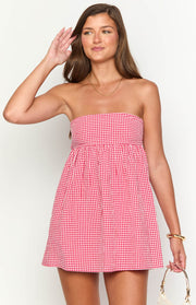 Close-up of the red gingham strapless mini dress with a gathered waist
