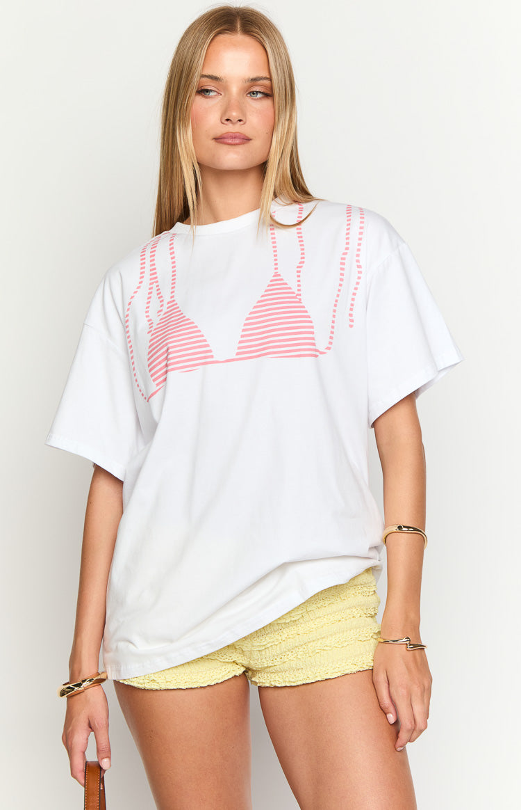 White oversized tee with a pink striped bikini top graphic and dotted lines on the front