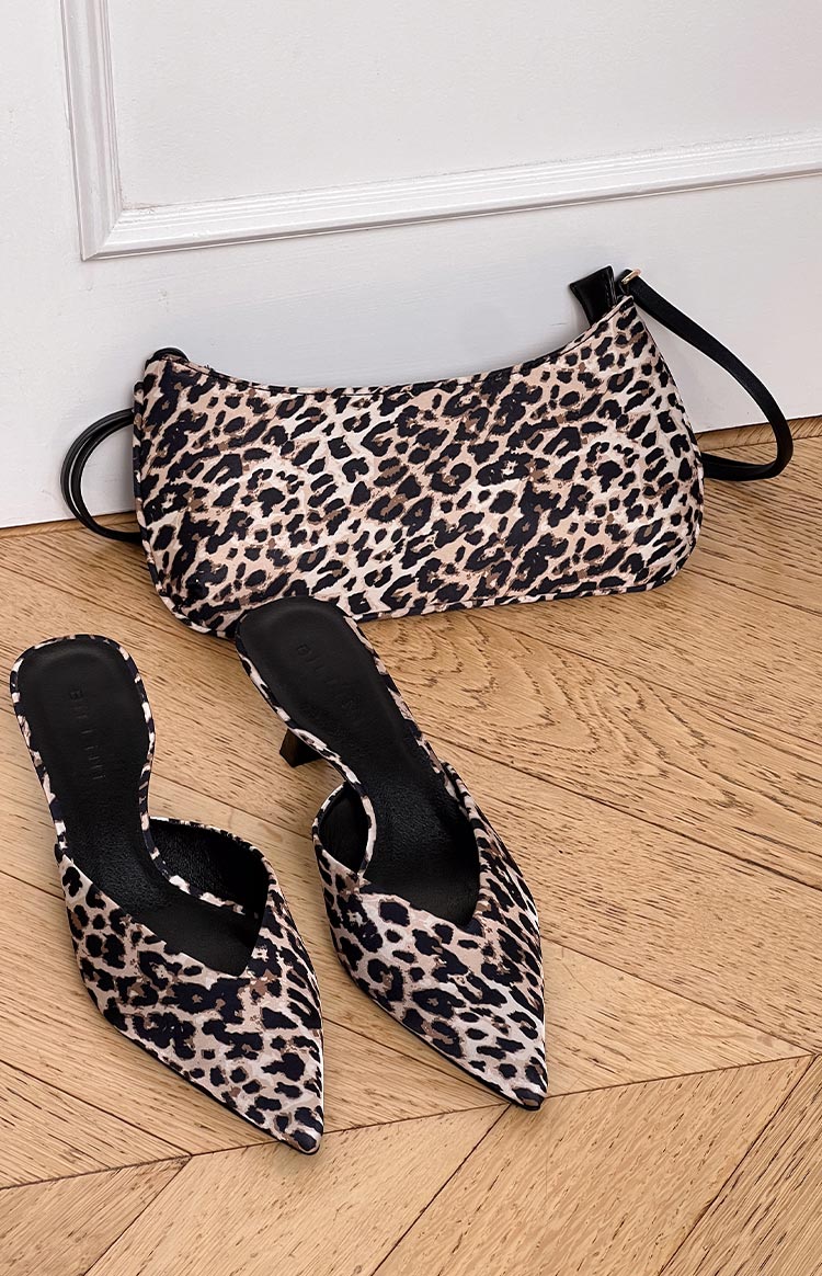pinterest style flat lay of leopard print heels with pointed toes and a triangle shaped upper styled with a matching leopard shoulder bag