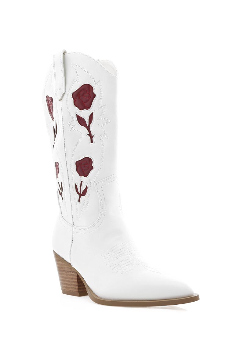 White cowboy boot with garnet red rose embroidery on the shaft, a pointed toe, and a brown stacked block heel