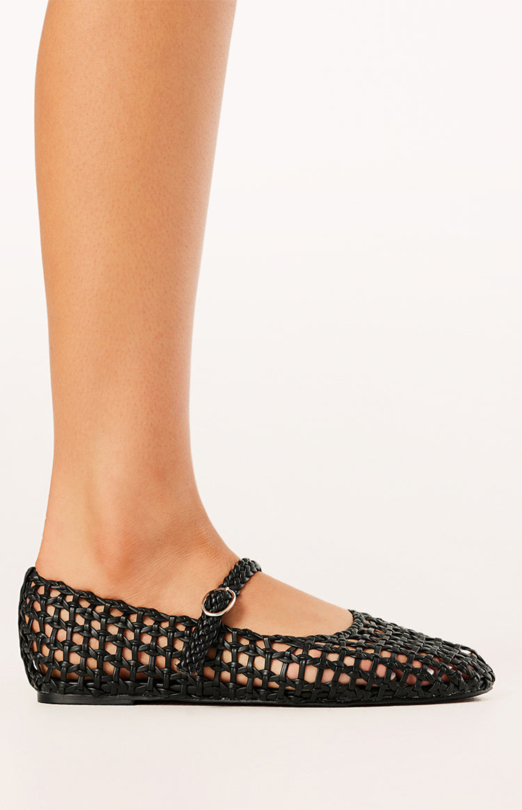 Side view of a black woven ballet flat with a Mary Jane strap and silver buckle
