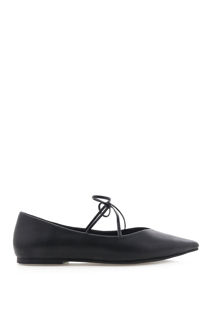 Side view of a black ballet flat with a pointed toe and thin lace-up ankle straps