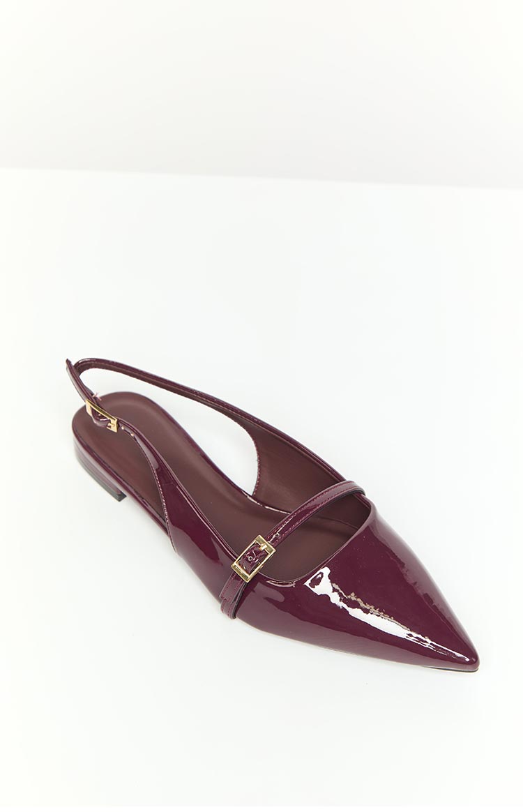 Side view of a mulberry patent flat shoe with a pointed toe, a thin strap across the vamp, and a slingback strap