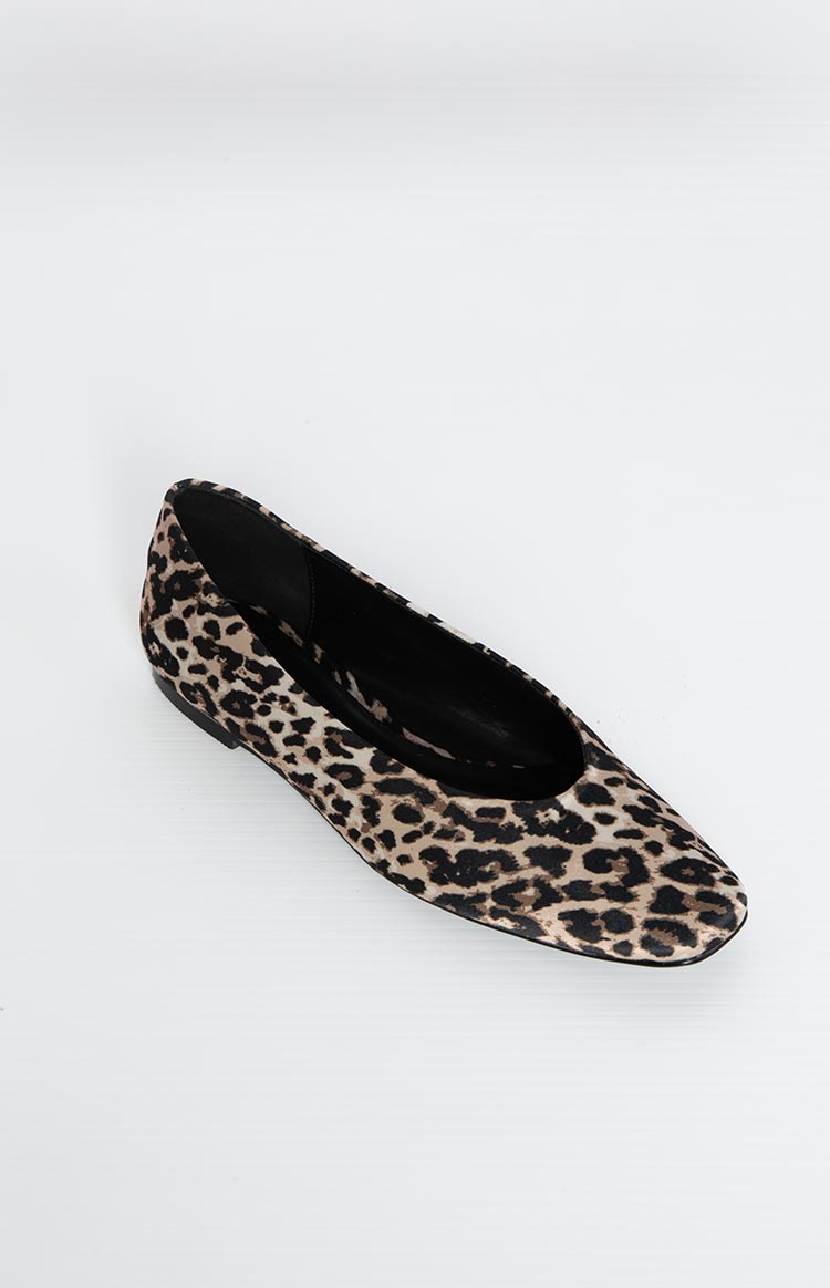 Angled top-down view of a leopard print ballet flat with a rounded toe and soft black sole