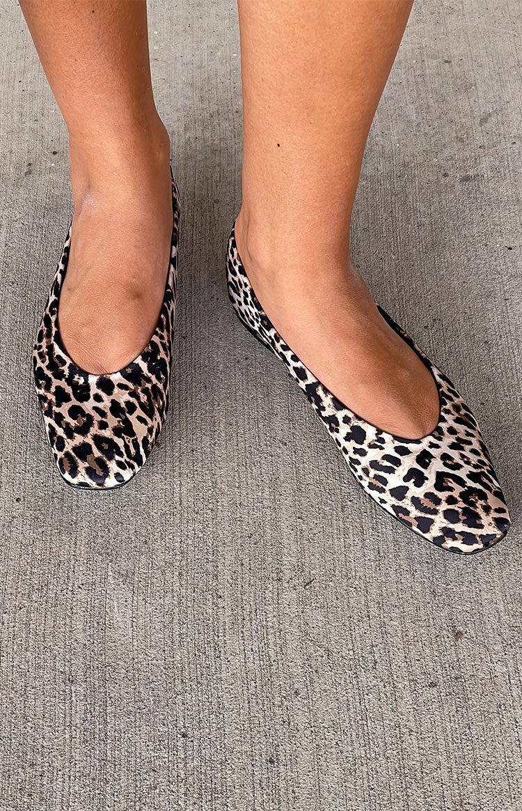 Overhead view of two leopard print ballet flats with a rounded toe and low cut vamp