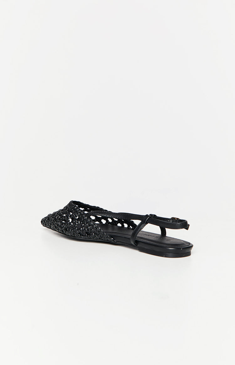 Side view of a black woven mule with a pointed toe, flat sole, and an adjustable ankle strap with buckle
