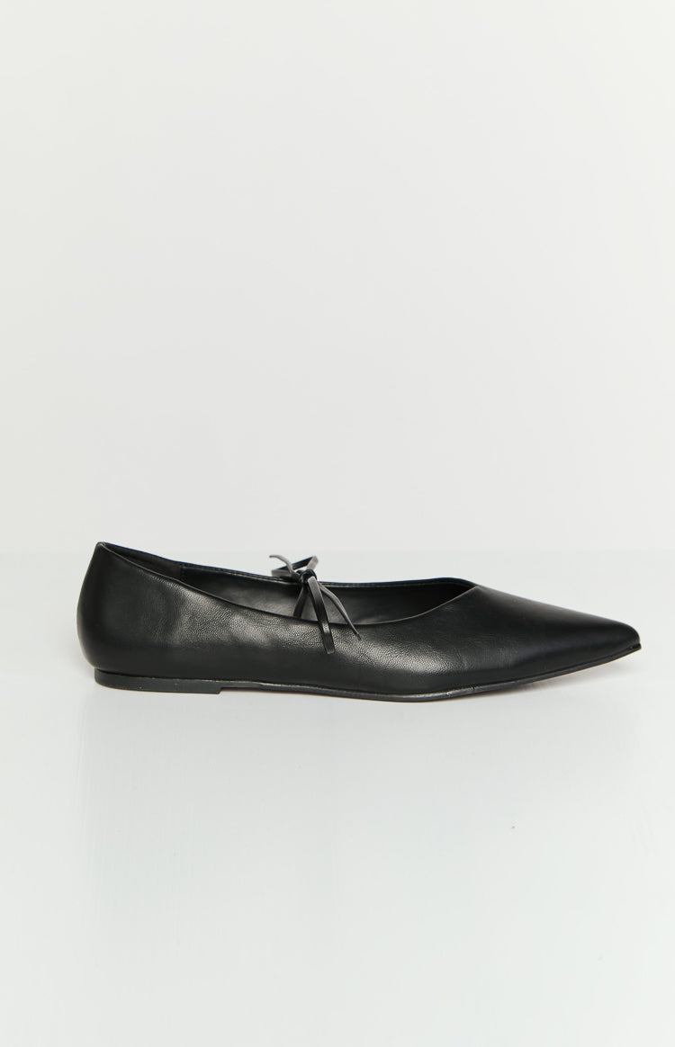 Side profile of a black leather ballet flat with a pointed toe and a small tie detail on the vamp