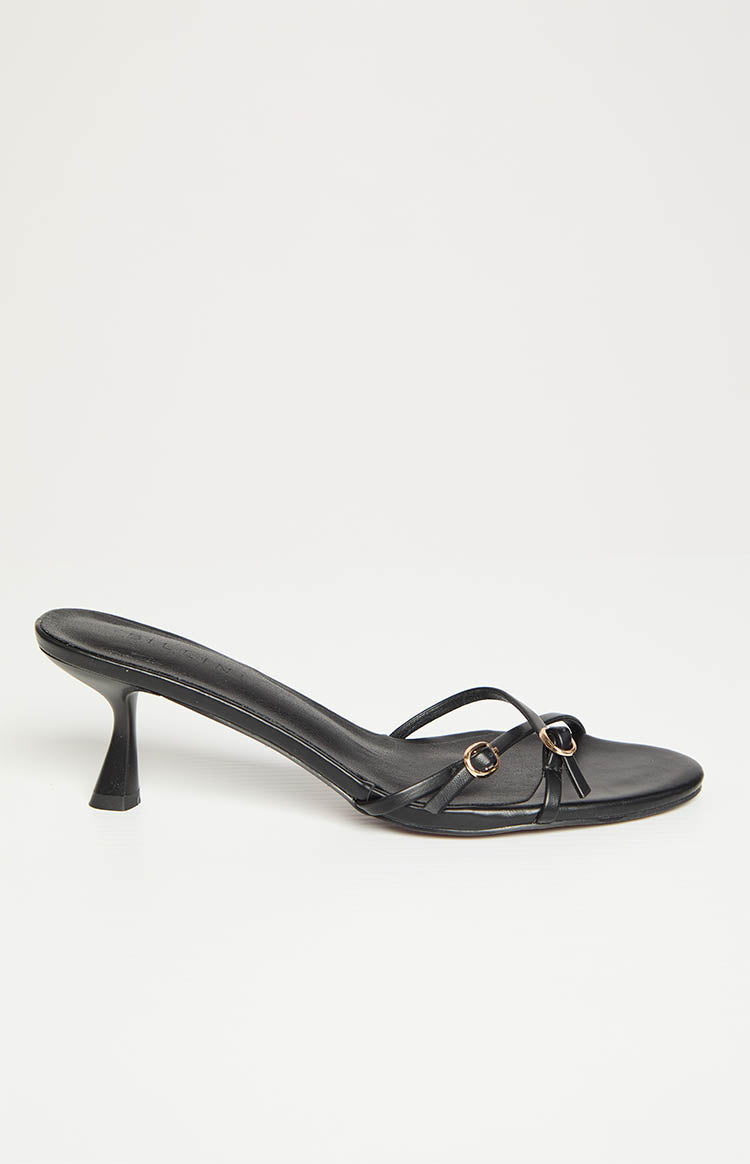 Side view of a black mule heel with a flared kitten heel and thin straps featuring gold ring details