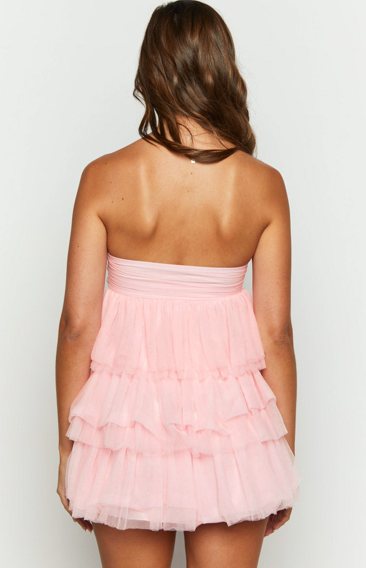 Rear view of a pink strapless mini dress with a ruched bodice and tiered ruffled tulle skirt