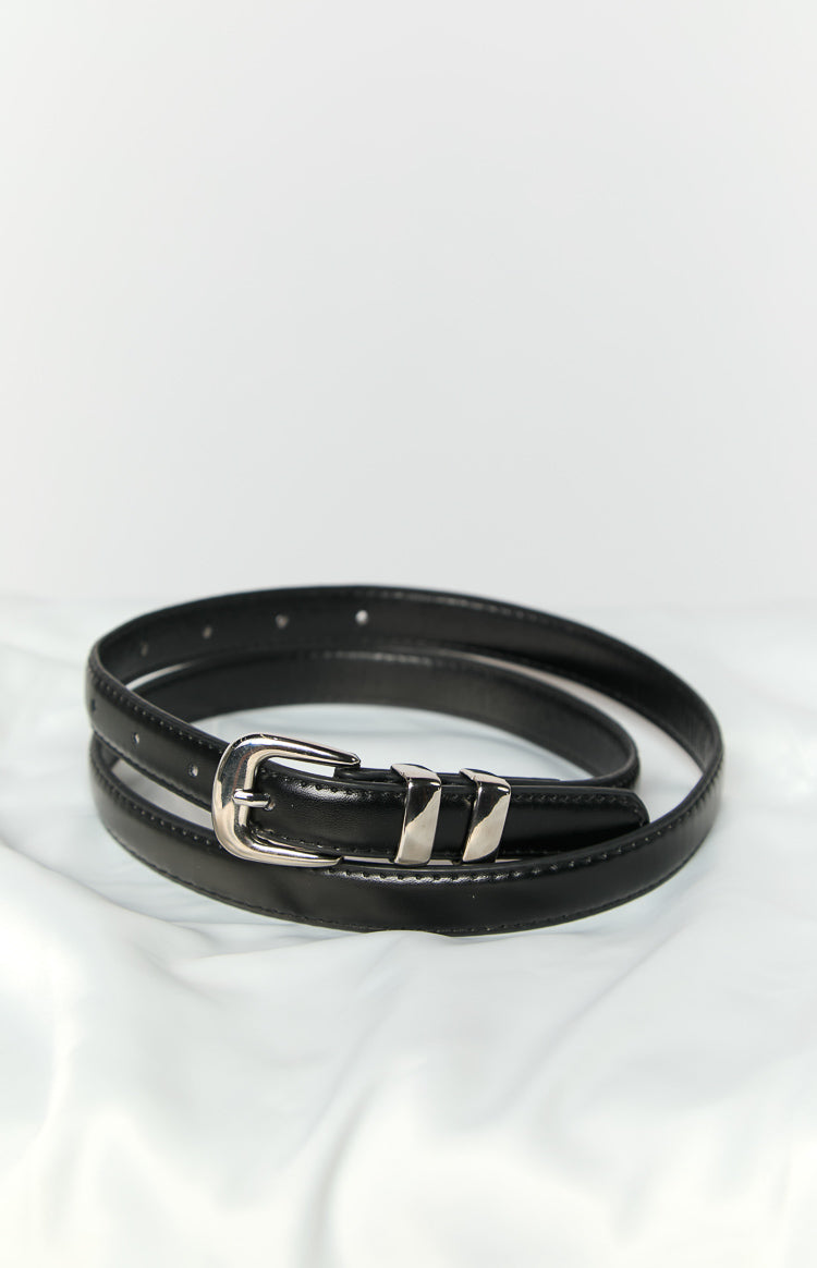 Close-up of a black PU belt coiled, highlighting the silver buckle and two silver keeper loops